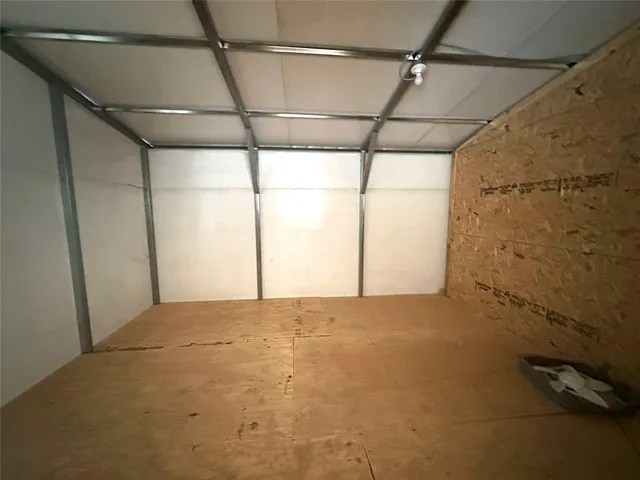 a view of house with backyard and furniture