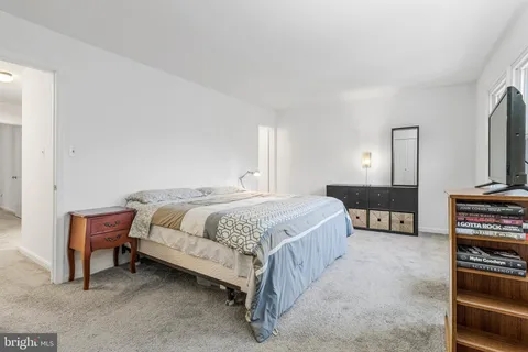 a spacious bedroom with a bed and a view of bathroom
