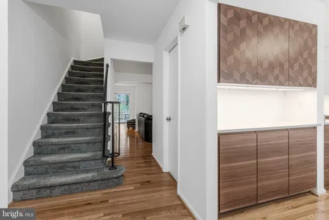 a view of a hallway with wooden floor and entryway