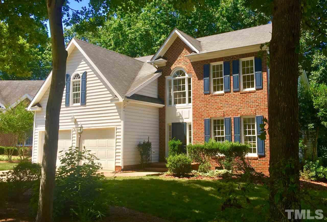 3305 Glade Spring Court Raleigh, NC 27612 - Photo 1 of 20 a view of a house with brick walls and a yard with plants