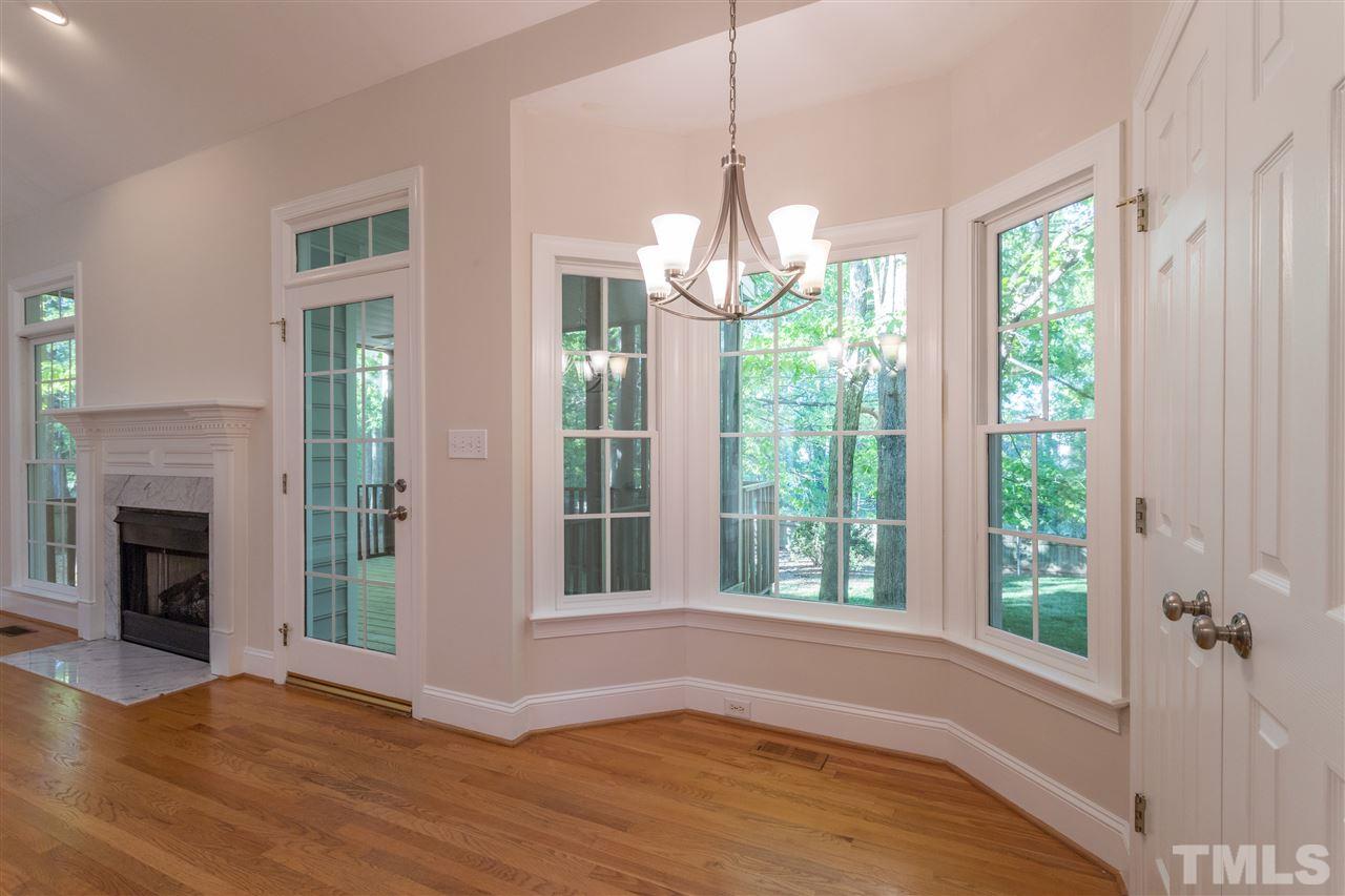 3305 Glade Spring Court Raleigh, NC 27612 - Photo 14 of 20 a view of empty room with wooden floor and fireplace