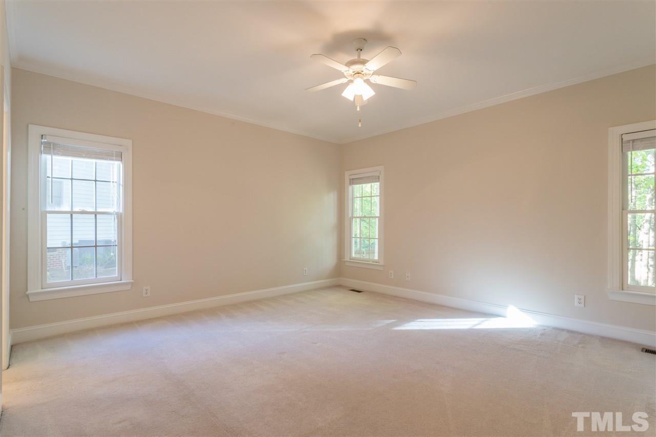 3305 Glade Spring Court Raleigh, NC 27612 - Photo 15 of 20 an empty room with windows and chandelier fan