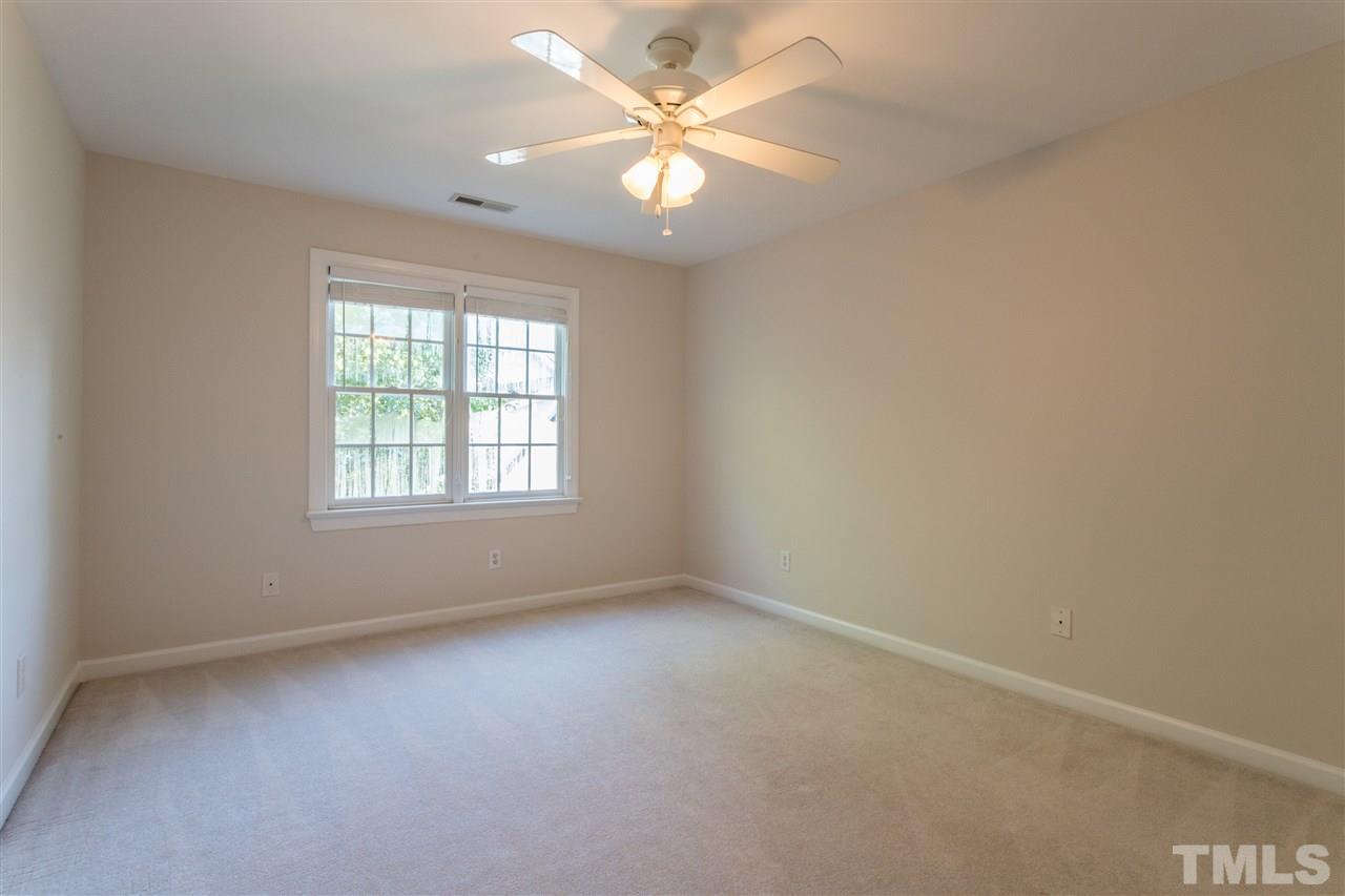 3305 Glade Spring Court Raleigh, NC 27612 - Photo 17 of 20 an empty room with windows and fan