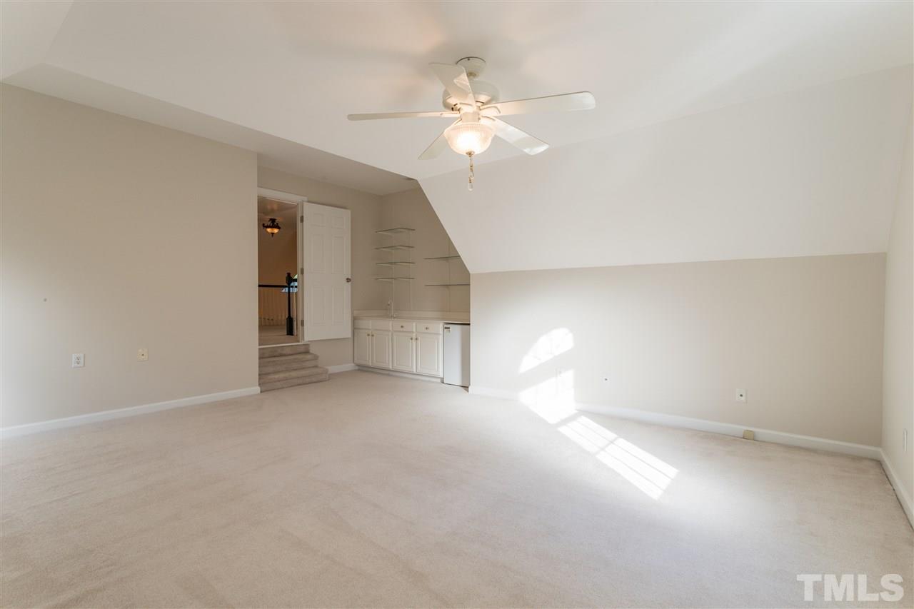 3305 Glade Spring Court Raleigh, NC 27612 - Photo 20 of 20 an empty room with windows and chandelier fan