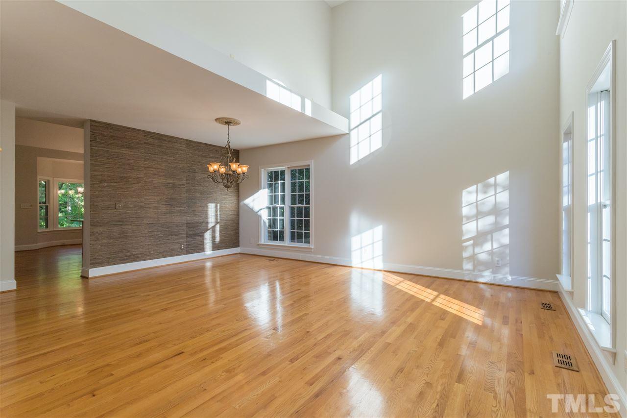 3305 Glade Spring Court Raleigh, NC 27612 - Photo 6 of 20 a view of an empty room with wooden floor and a window