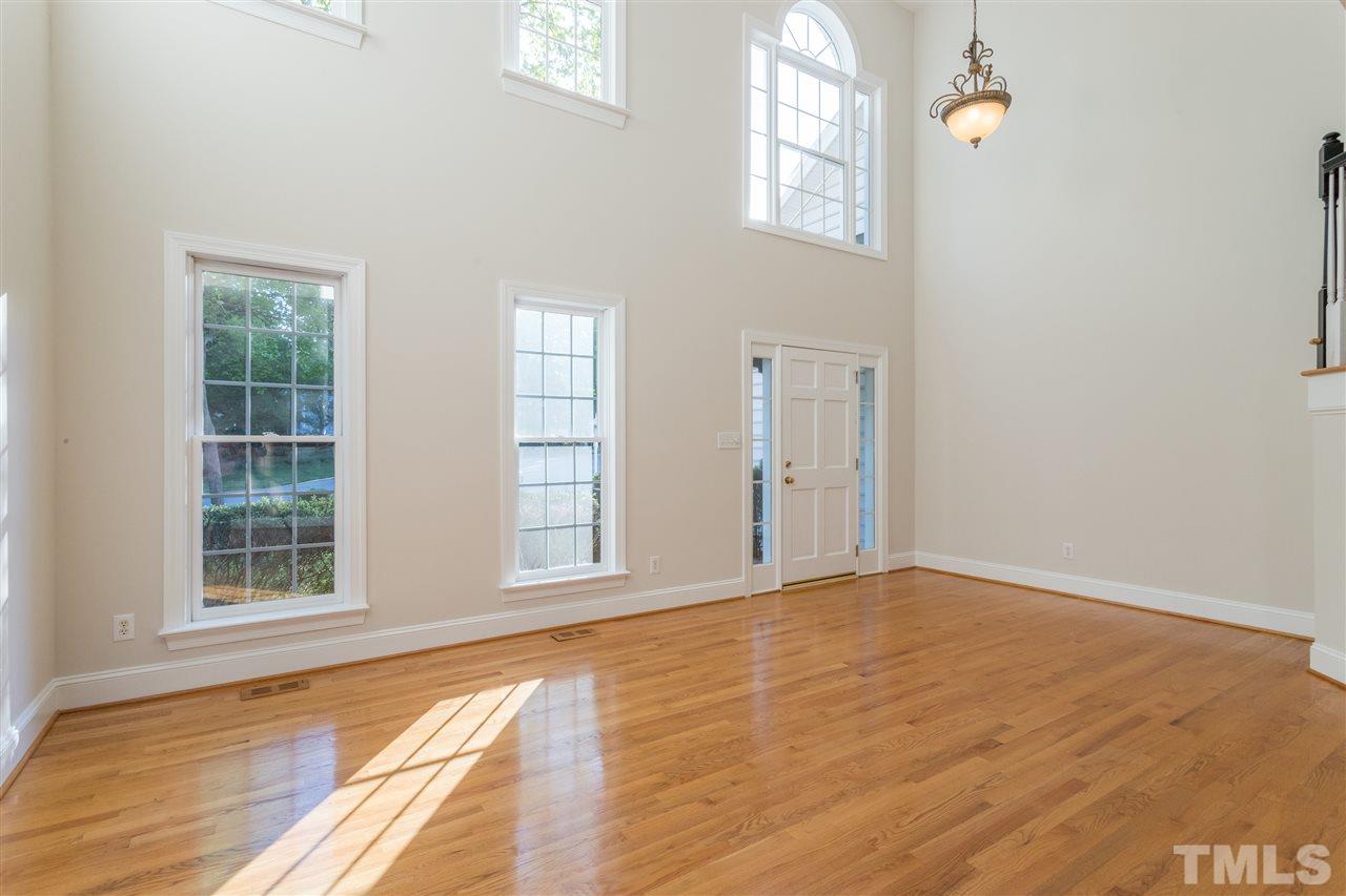 3305 Glade Spring Court Raleigh, NC 27612 - Photo 8 of 20 an empty room with wooden floor and windows