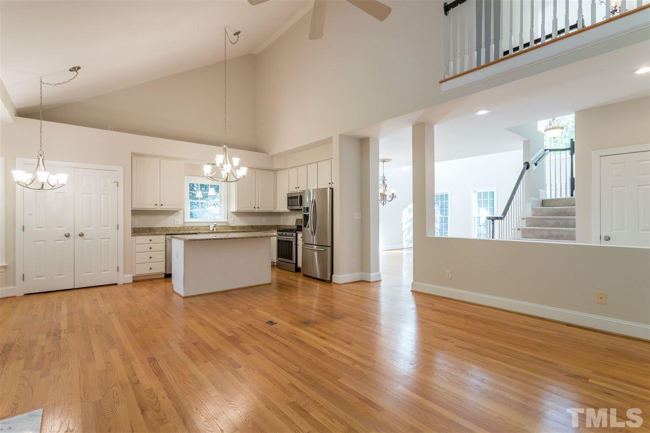 3305 Glade Spring Court Raleigh, NC 27612 - Photo 9 of 20 a large kitchen with stainless steel appliances kitchen island a large counter top and a wooden floors
