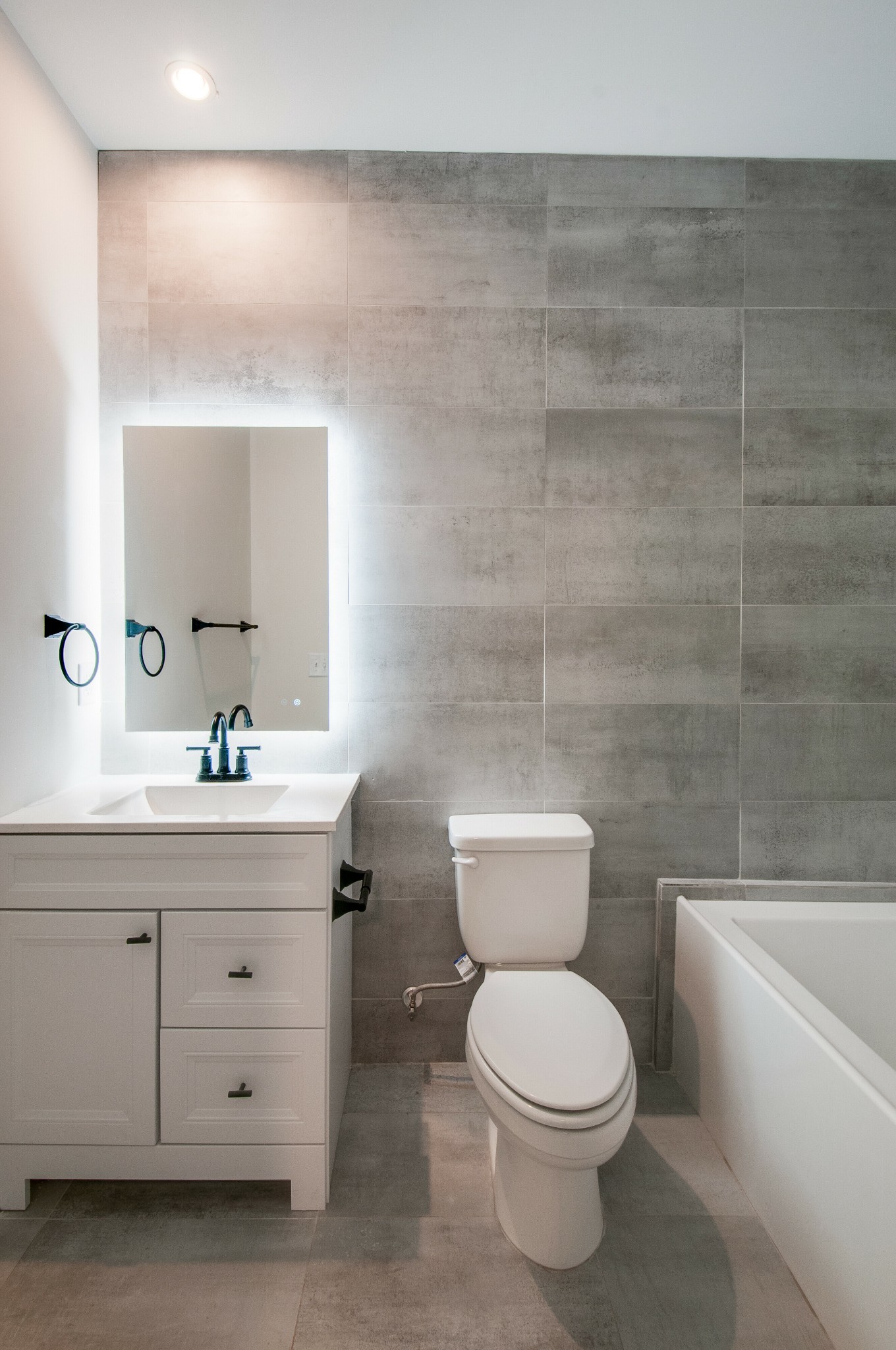 556 Rosedale Avenue, Unit 1 Nashville, TN 37211 - Photo 23 of 33 a bathroom with a granite countertop toilet a sink and a mirror