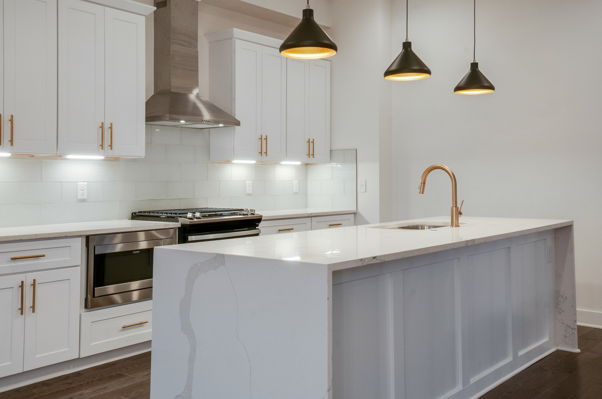 556 Rosedale Avenue, Unit 1 Nashville, TN 37211 - Photo 3 of 33 a kitchen with stainless steel appliances a sink a stove and white cabinets