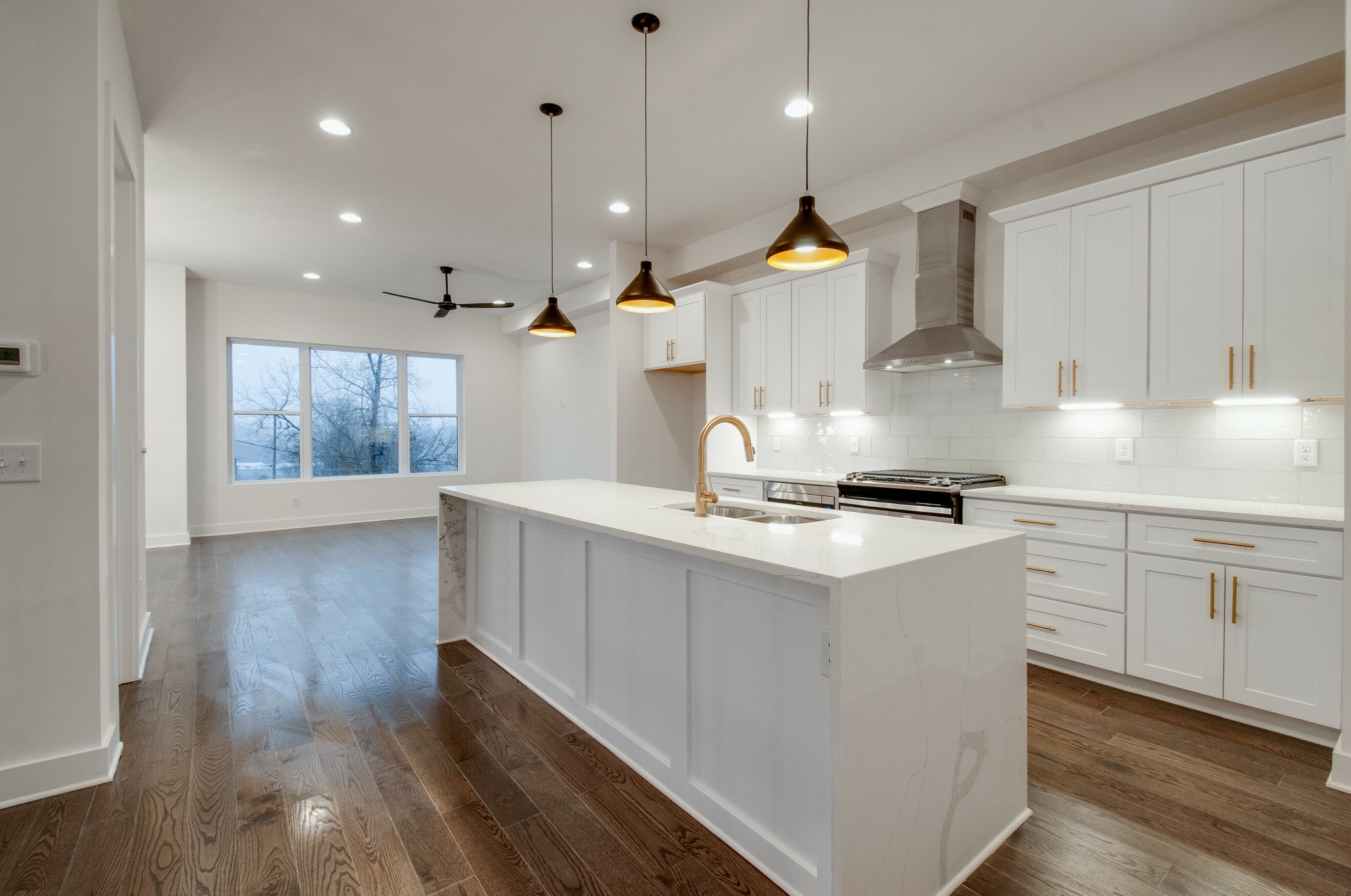 556 Rosedale Avenue, Unit 1 Nashville, TN 37211 - Photo 4 of 33 a kitchen with kitchen island a stove a sink a center island and wooden floor