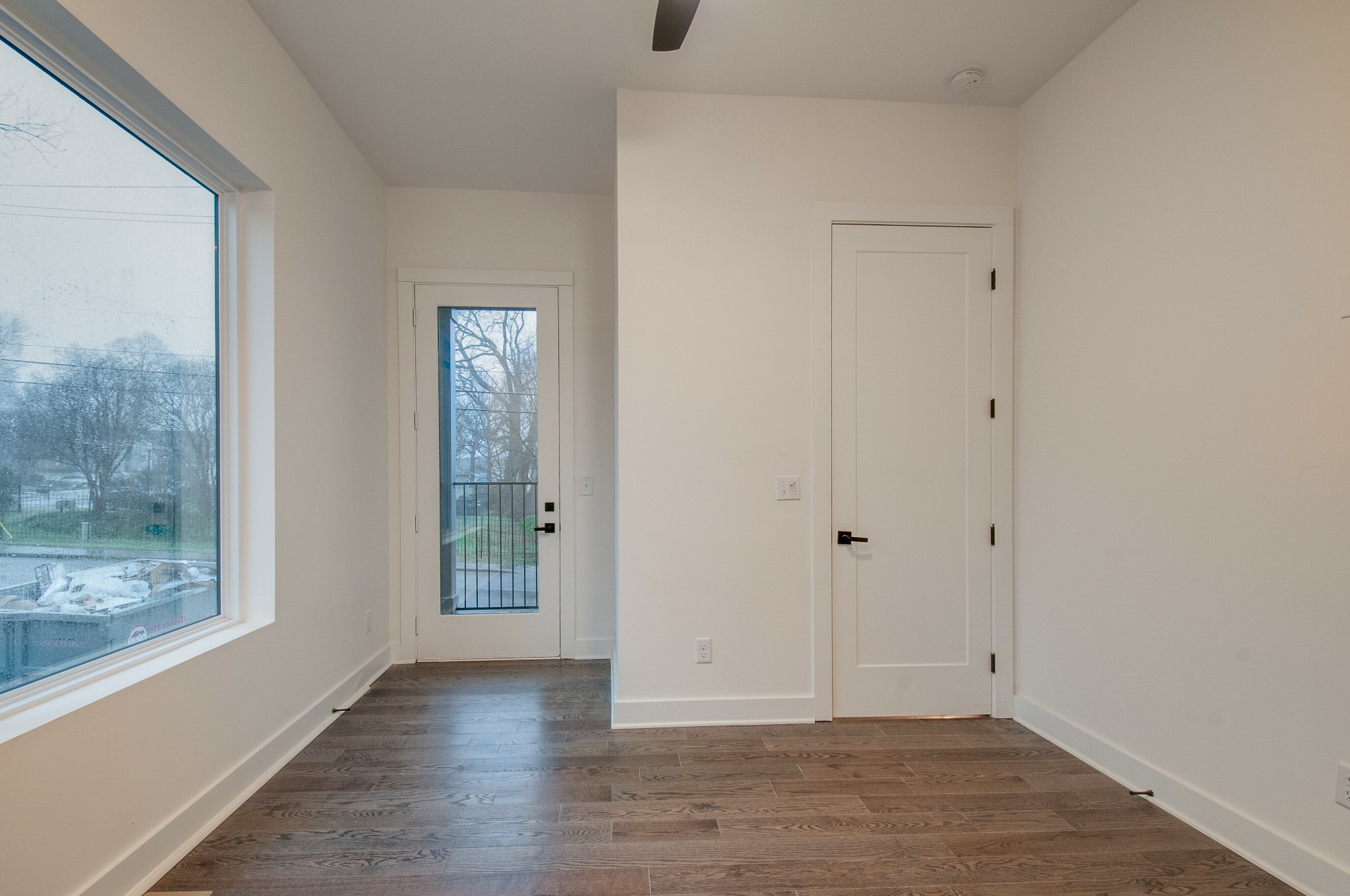 556 Rosedale Avenue, Unit 1 Nashville, TN 37211 - Photo 8 of 33 a view of an empty room with wooden floor and a window