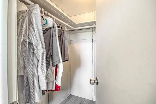 a view of walk in closet with clothes