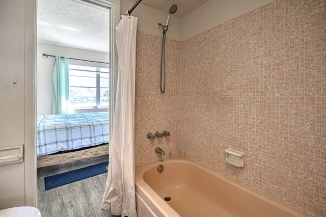 a bathroom with a tub and shower