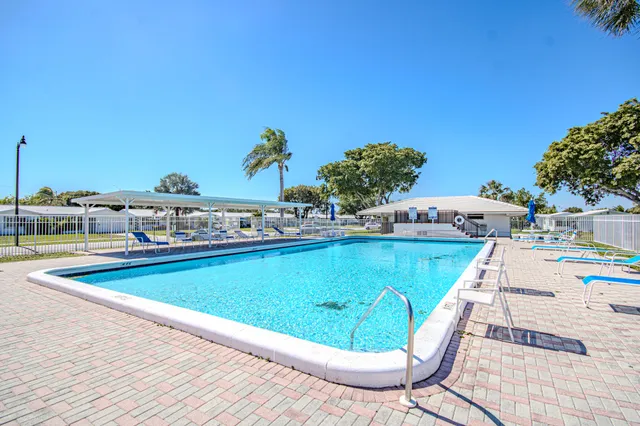 a view of a swimming pool with an outdoor seating