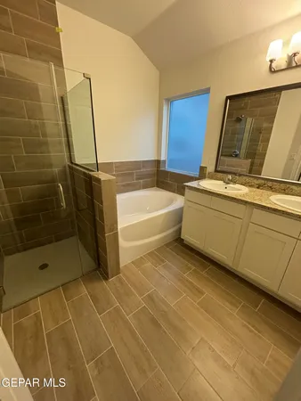 a bathroom with a bathtub and shower