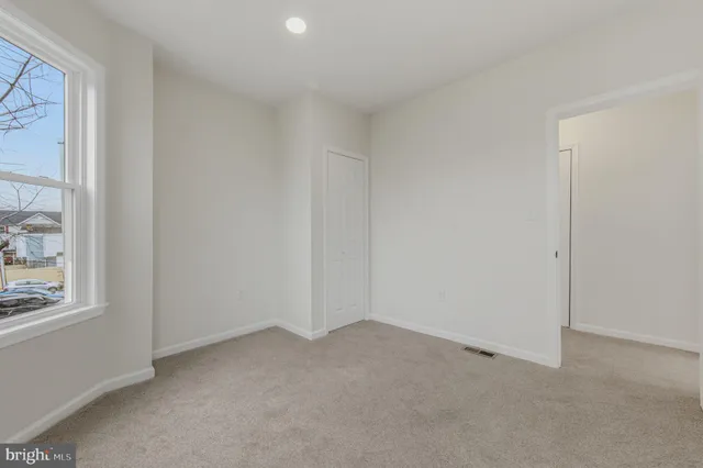 a view of an empty room and a window