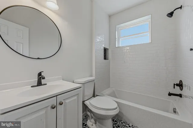 a bathroom with a sink toilet and a mirror