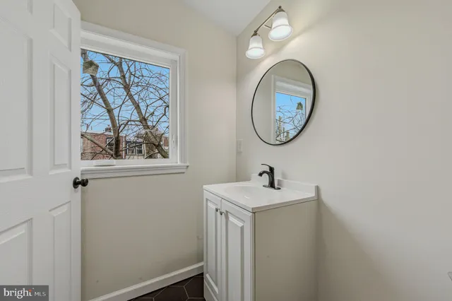 a bathroom with a toilet a sink and a mirror