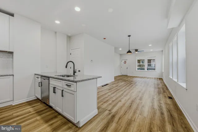 a kitchen with stainless steel appliances granite countertop a stove and a sink
