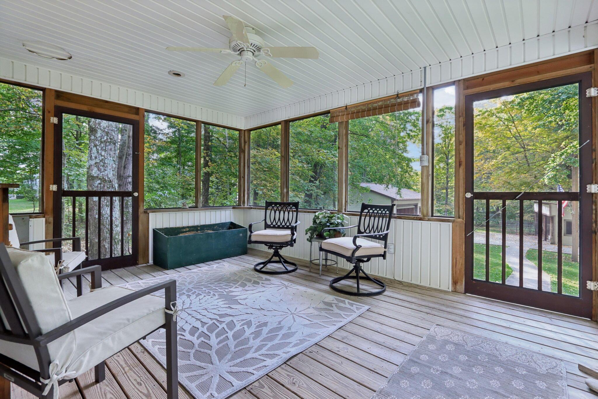 7115 Watkins Road Southwest Pataskala, OH 43062 - Photo 4 of 43 Screened porch with firewood storage box and pet escape door to fenced pen area