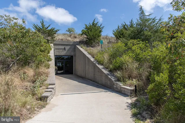 a man walking down a street next to a building