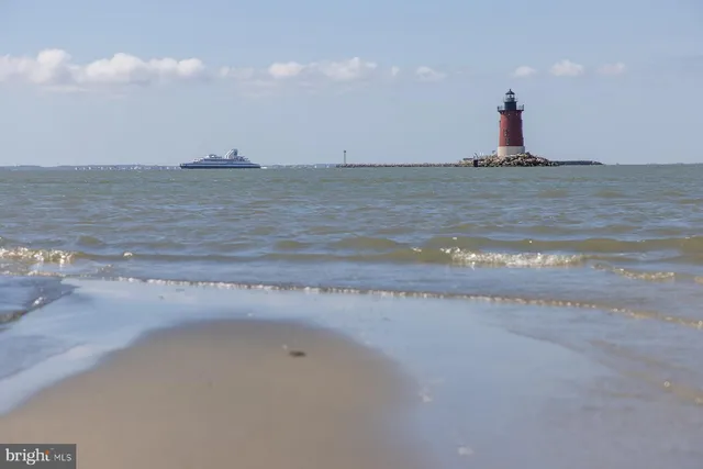 a view of a lake with houses in the back