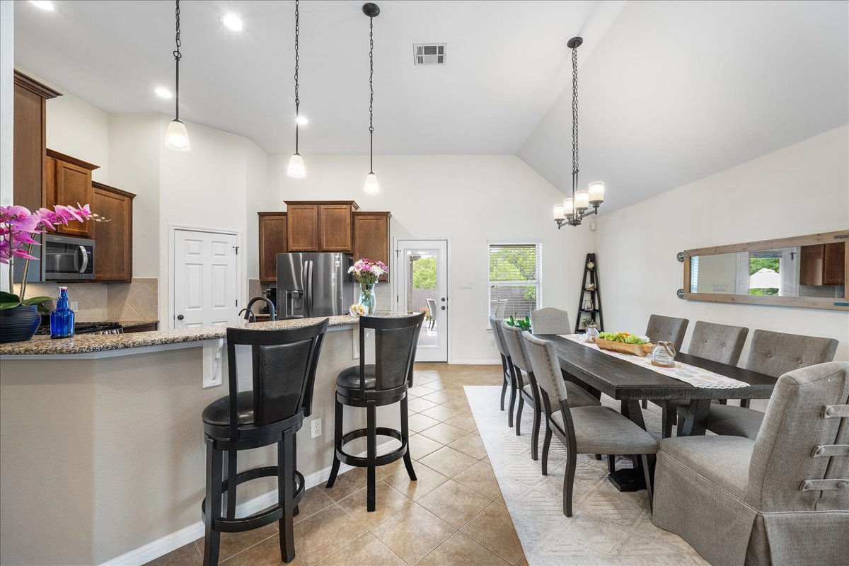 3000 Rio Verde Drive Leander, TX 78641 - Photo 7 of 23 a view of a dining room and livingroom with furniture wooden floor a chandelier