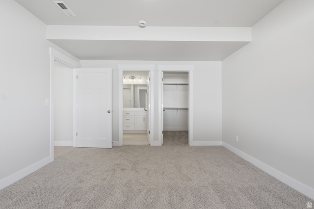 677 East 800 S Street Springville, UT 84663 - Photo 12 of 35 Unfurnished bedroom featuring connected bathroom, a walk in closet, and light colored carpet