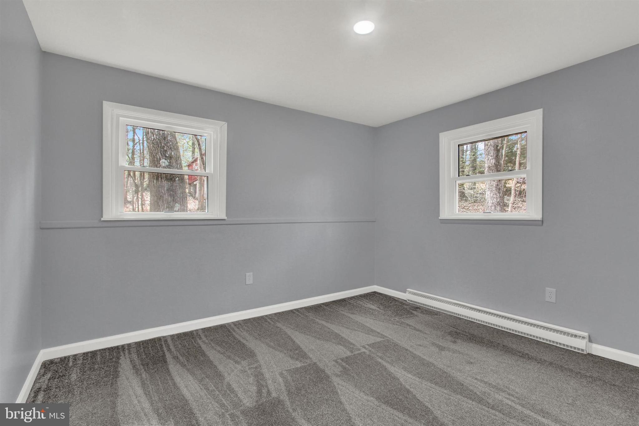 203 Pebble Lane Biglerville, PA 17307 - Photo 18 of 29 a view of an empty room with wooden floor and a window