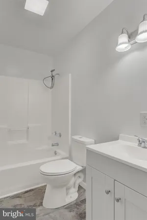 a bathroom with a sink a toilet and a bathtub