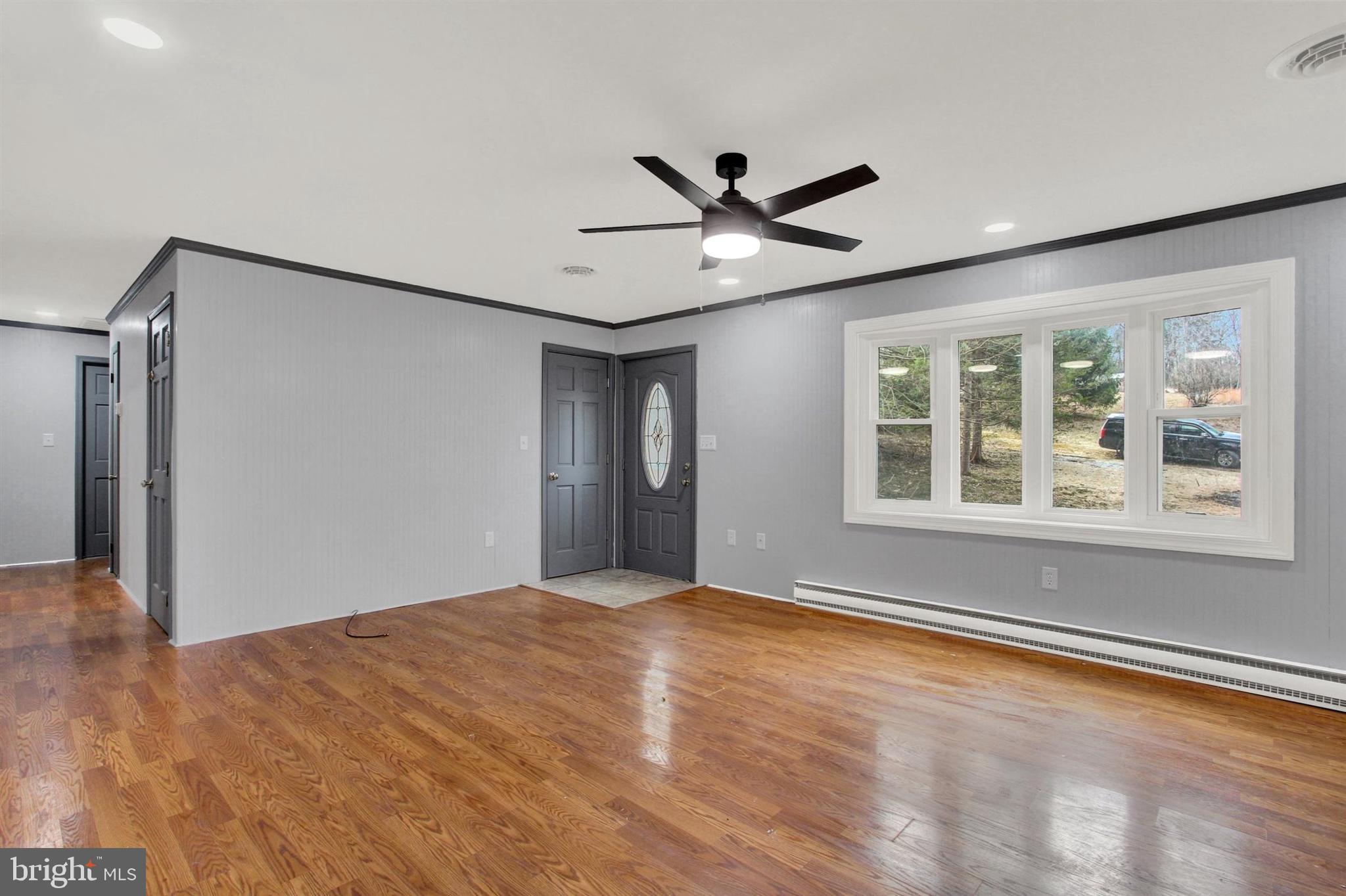 203 Pebble Lane Biglerville, PA 17307 - Photo 8 of 29 a view of an empty room with a window and wooden floor