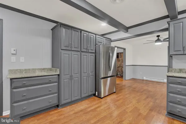a view of an empty room with cabinet wooden floor and a cabinet