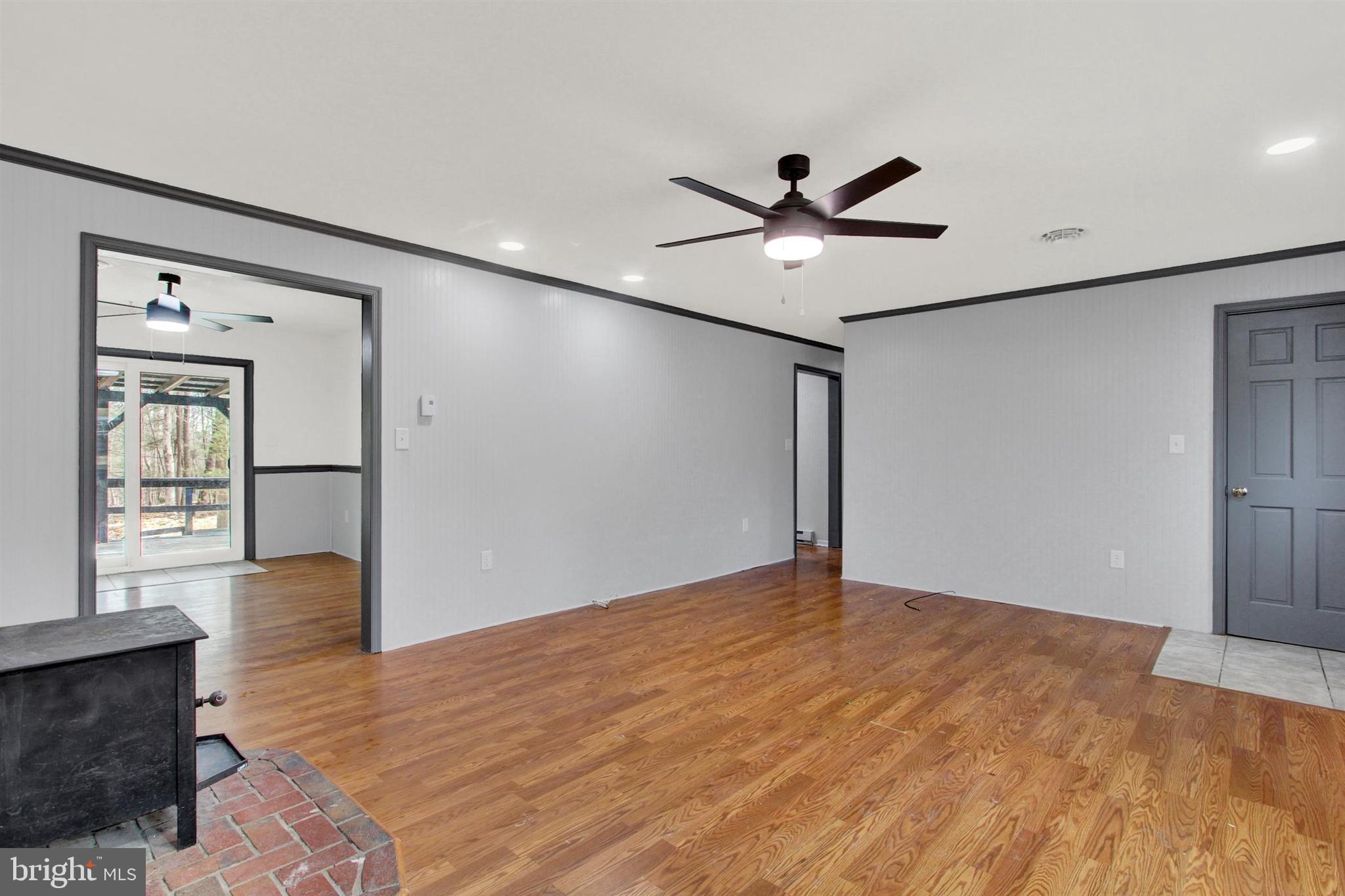 203 Pebble Lane Biglerville, PA 17307 - Photo 10 of 29 a view of an empty room with window and wooden floor