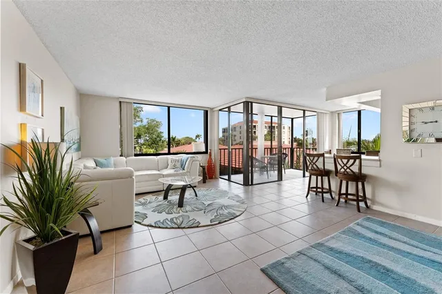 a living room with furniture large window and glass door