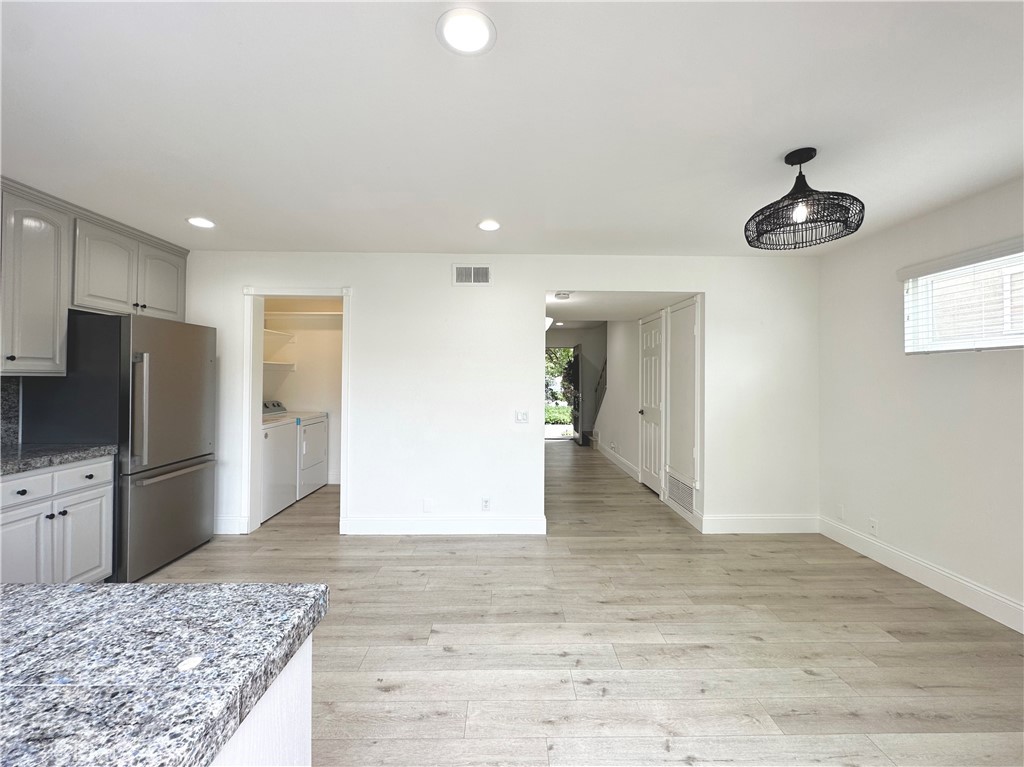 13 Greenleaf, Unit 5 Irvine, CA 92604 - Photo 14 of 30 an empty space with kitchen island and stainless steel appliances