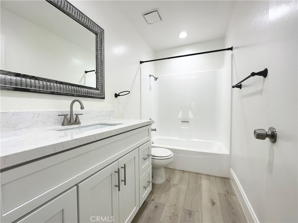 13 Greenleaf, Unit 5 Irvine, CA 92604 - Photo 20 of 30 a bathroom with a sink a toilet a mirror a vanity and shower