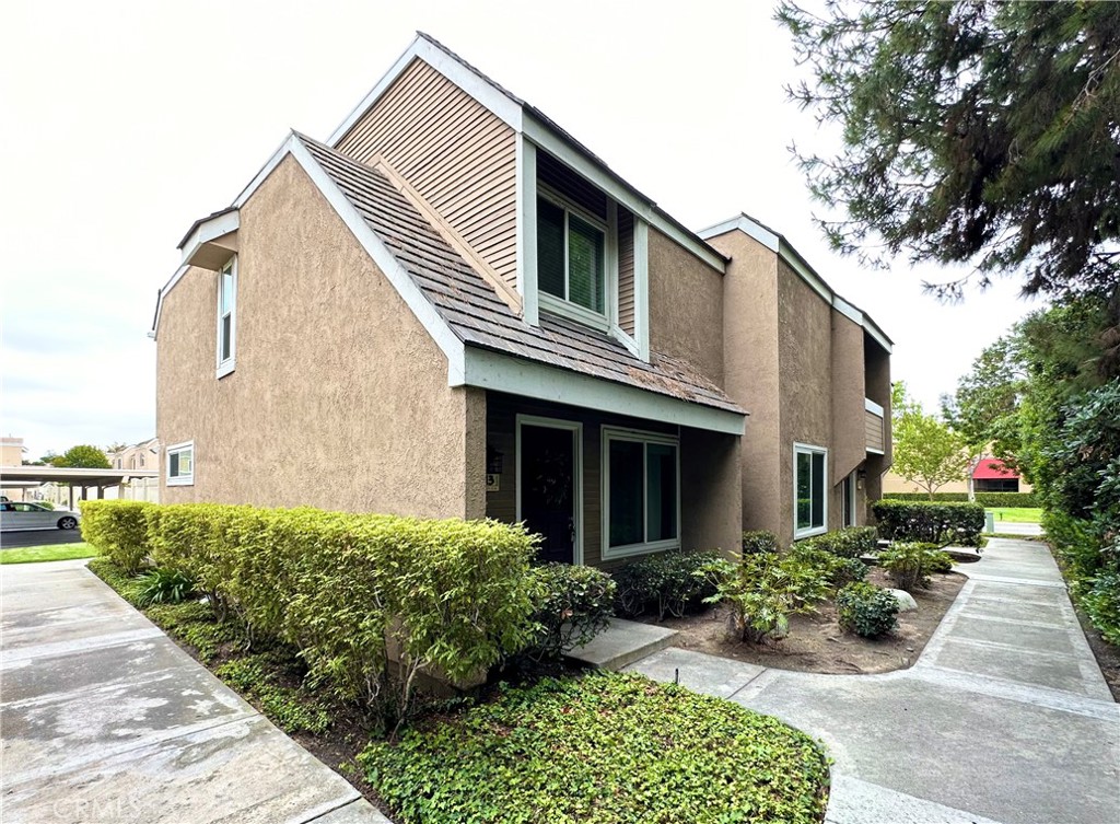 13 Greenleaf, Unit 5 Irvine, CA 92604 - Photo 2 of 30 a front view of a house with a yard