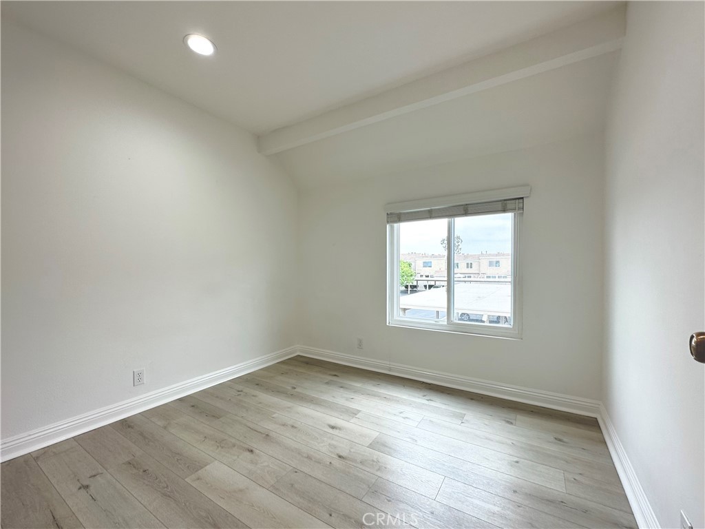 13 Greenleaf, Unit 5 Irvine, CA 92604 - Photo 21 of 30 an empty room with wooden floor and windows