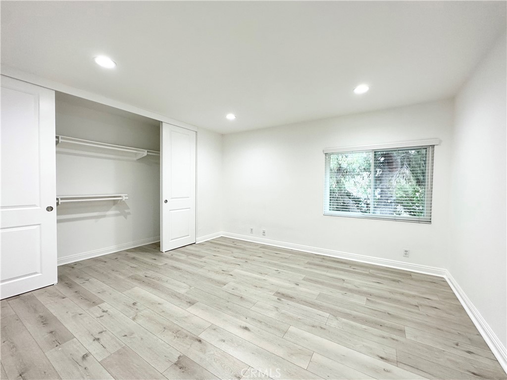 13 Greenleaf, Unit 5 Irvine, CA 92604 - Photo 24 of 30 a view of an empty room with window and wooden floor