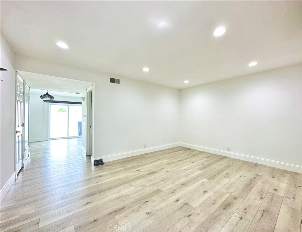 13 Greenleaf, Unit 5 Irvine, CA 92604 - Photo 3 of 30 an empty room with wooden floor and windows