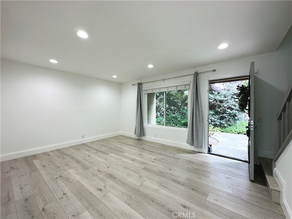 13 Greenleaf, Unit 5 Irvine, CA 92604 - Photo 6 of 30 a view of an empty room with wooden floor and a window