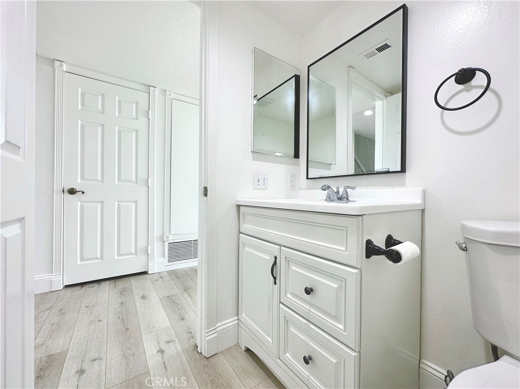 13 Greenleaf, Unit 5 Irvine, CA 92604 - Photo 8 of 30 a bathroom with a granite countertop sink toilet a mirror and shower