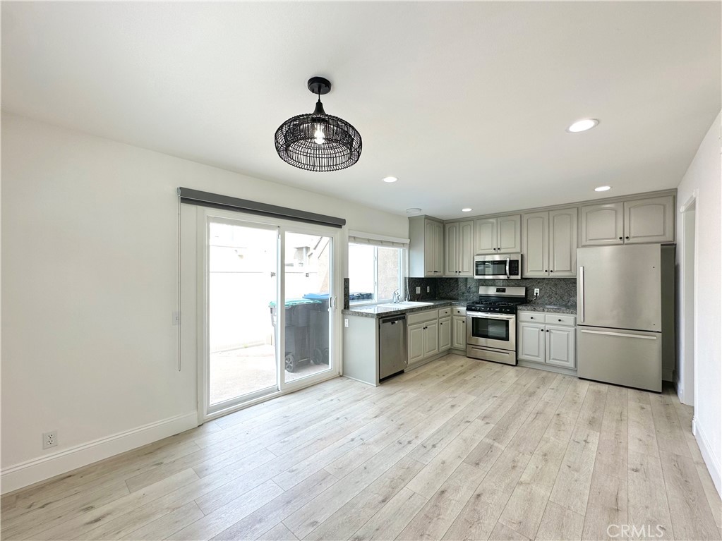 13 Greenleaf, Unit 5 Irvine, CA 92604 - Photo 9 of 30 a kitchen with stainless steel appliances a refrigerator and a stove top oven