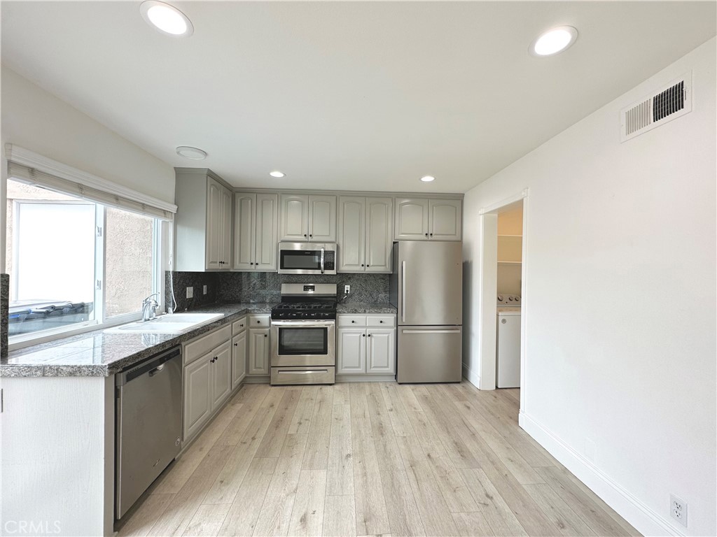 13 Greenleaf, Unit 5 Irvine, CA 92604 - Photo 10 of 30 a kitchen with a sink stainless steel appliances and cabinets