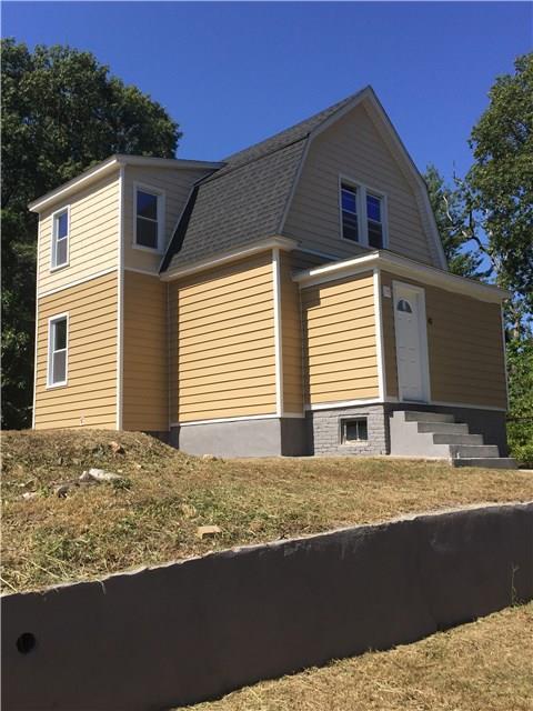 a view of house with backyard