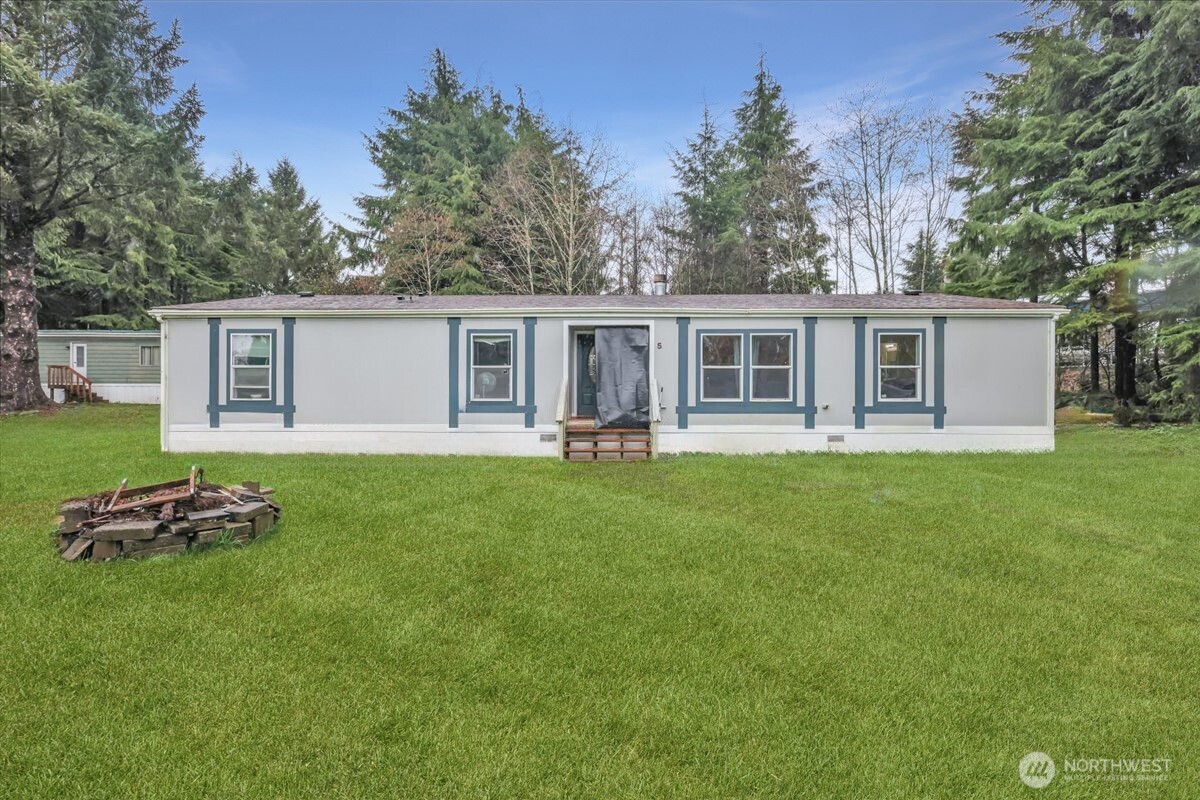 5 Cherokee Place Copalis Beach, WA 98535 - Photo 1 of 16 a front view of house with yard and trees in the background
