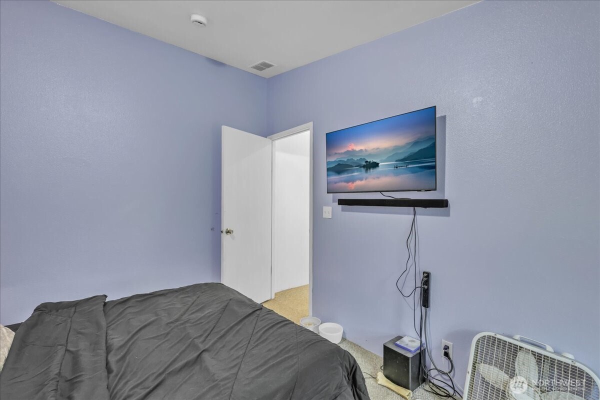 5 Cherokee Place Copalis Beach, WA 98535 - Photo 16 of 16 a bedroom with a bed and a chandelier