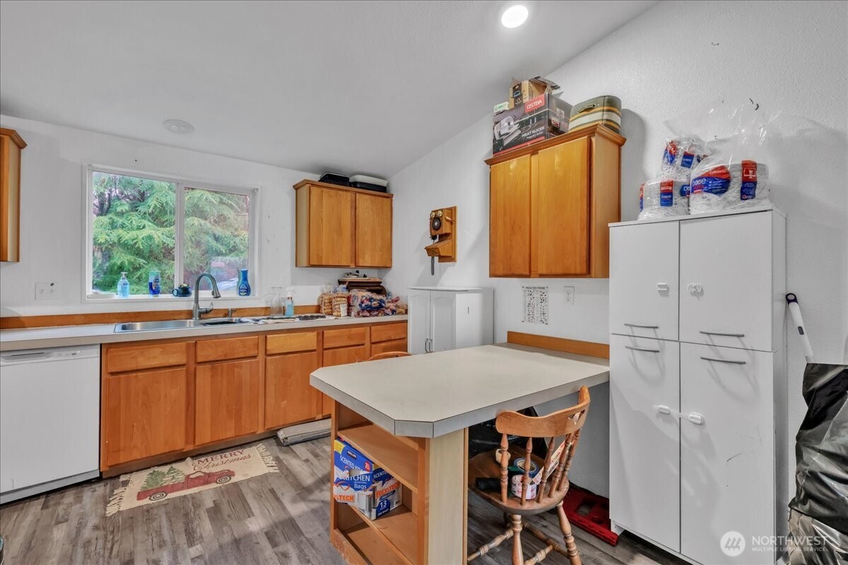 5 Cherokee Place Copalis Beach, WA 98535 - Photo 5 of 16 a kitchen that has a cabinets and a table in it