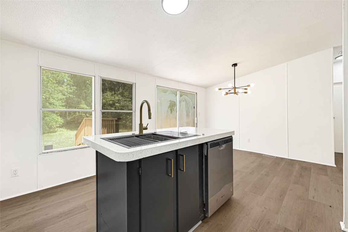 16315 Lone Star Ranch Drive Conroe, TX 77302 - Photo 13 of 20 a kitchen with a sink stove and wooden floor