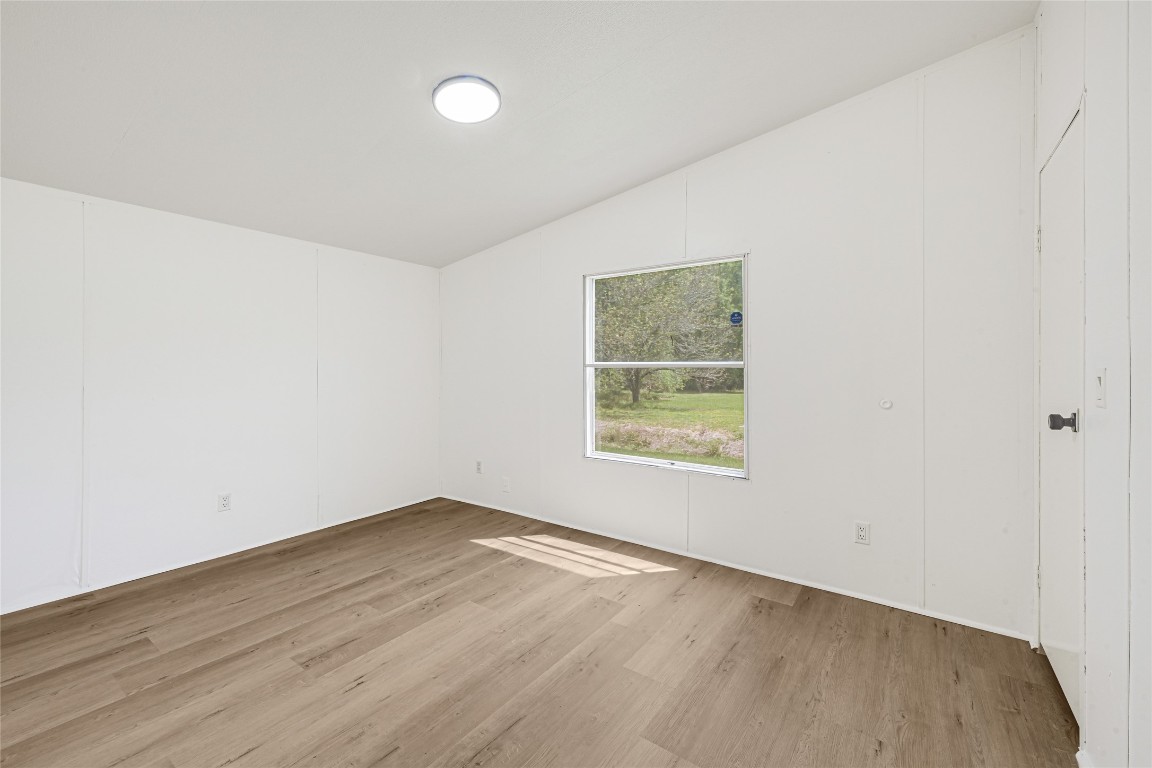 16315 Lone Star Ranch Drive Conroe, TX 77302 - Photo 16 of 20 an empty room with wooden floor and windows